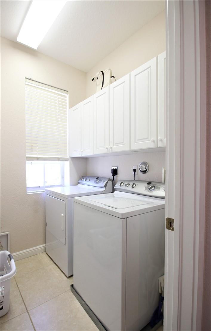 8316 Northwest 8th Terrace Boca Raton, FL 33487 - Photo 24 of 34 a utility room with cabinets washer and dryer