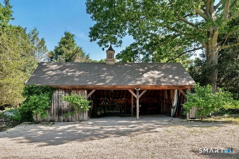 261-1 Grassy Hill Road Lyme, CT 06371 - Photo 3 of 40 The charming English-style carriage shed offers the perfect space for parking, a workshop, or a delightful potting shed.