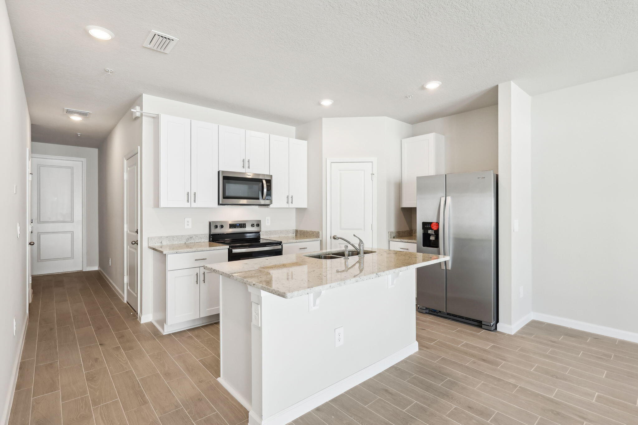 478 Salisbury Circle Fort Pierce, FL 34982 - Photo 11 of 35 a kitchen with stainless steel appliances granite countertop a refrigerator a stove top oven a sink and dishwasher with wooden floor