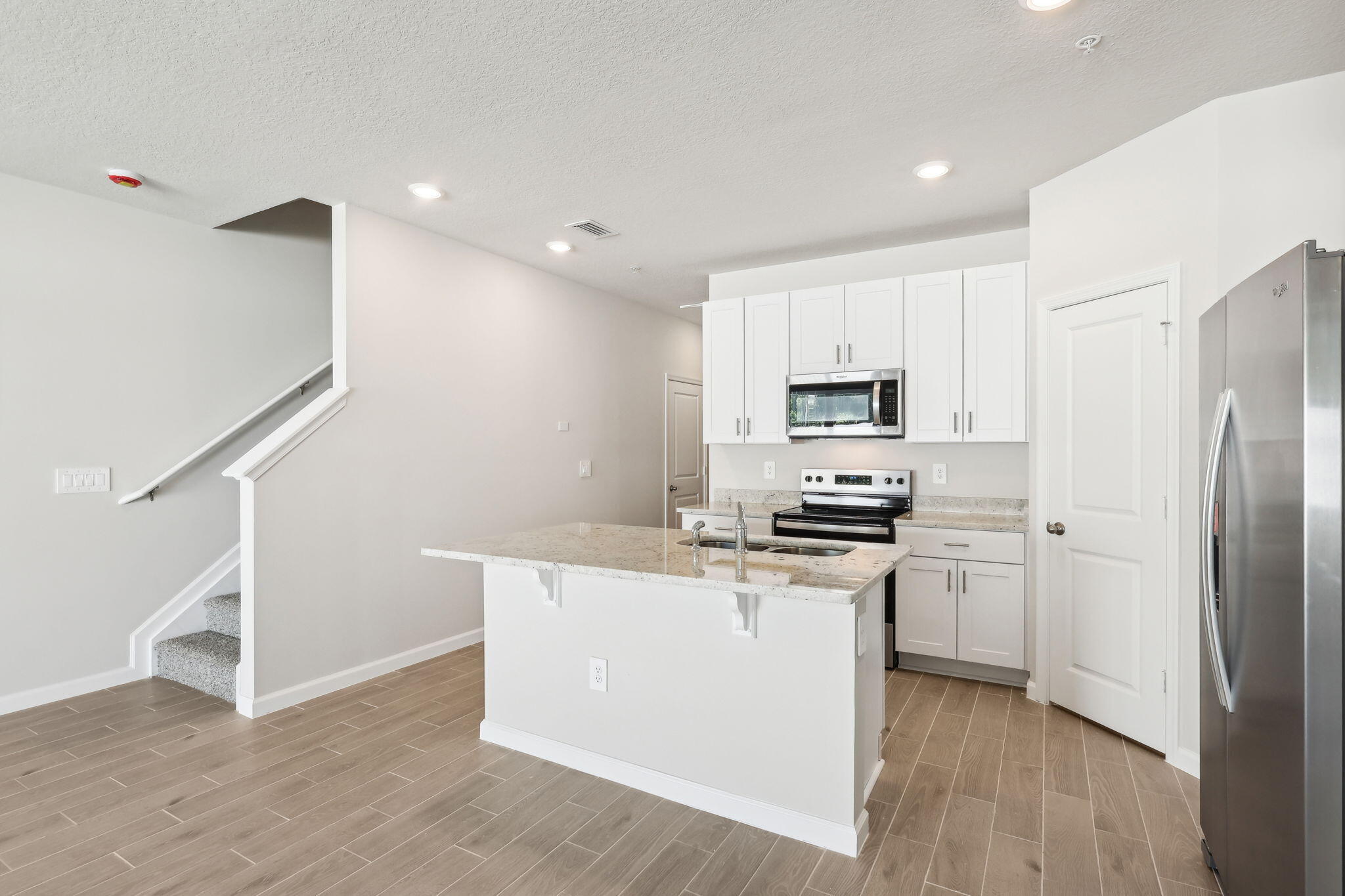 478 Salisbury Circle Fort Pierce, FL 34982 - Photo 12 of 35 a kitchen with wooden cabinets and stainless steel appliances