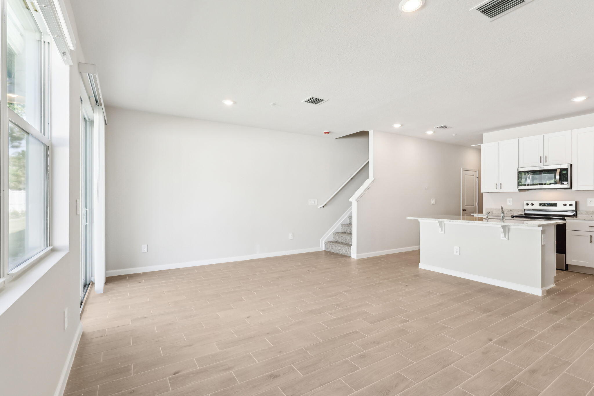 478 Salisbury Circle Fort Pierce, FL 34982 - Photo 6 of 35 a view of an empty room with kitchen and a window