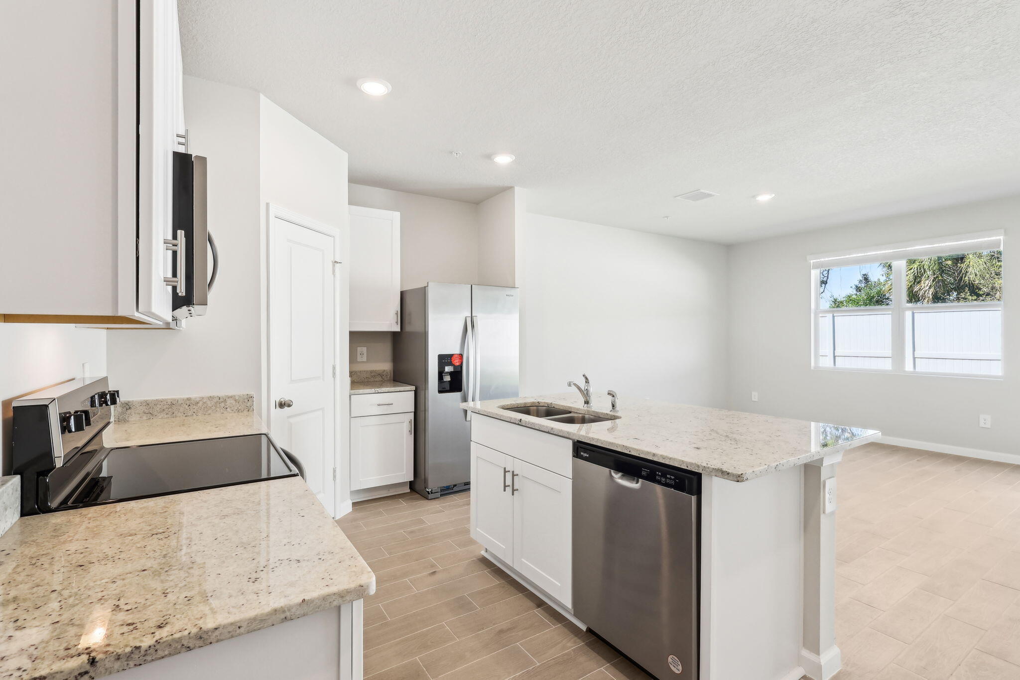 478 Salisbury Circle Fort Pierce, FL 34982 - Photo 10 of 35 a kitchen with stainless steel appliances granite countertop a sink stove and refrigerator