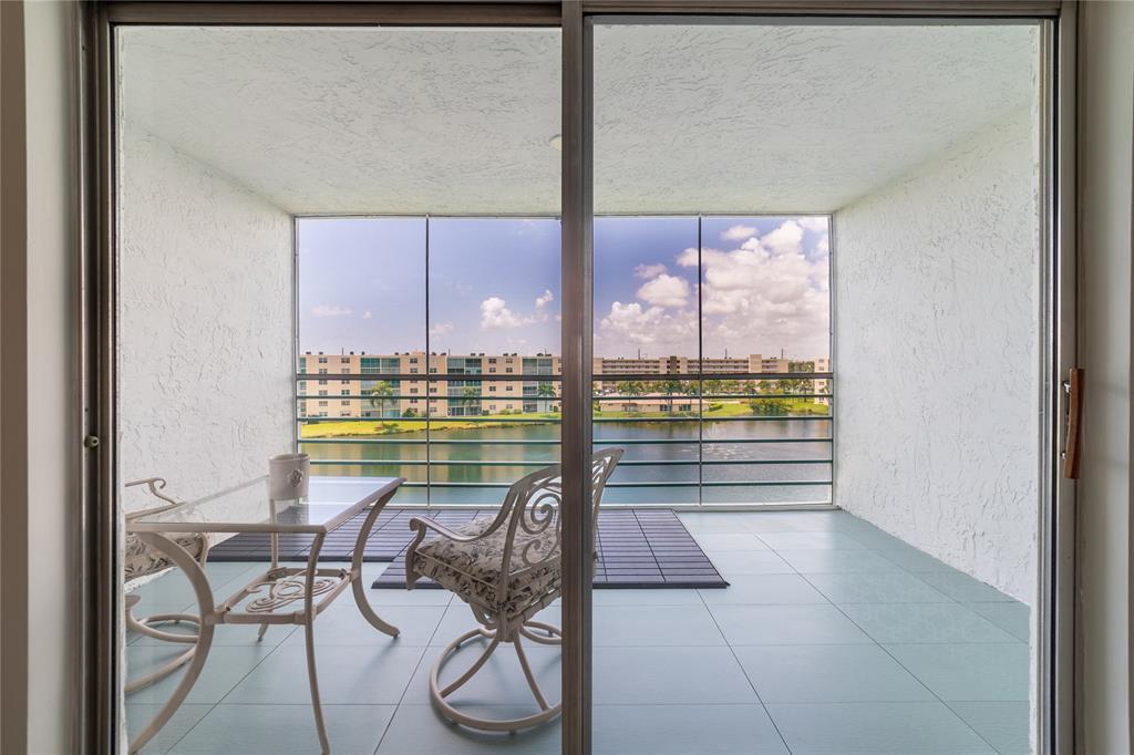 a view of a swimming pool and outdoor seating