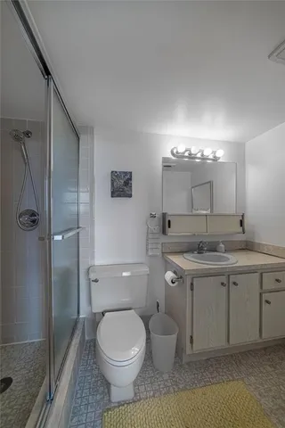 a bedroom with a bed a desk and chair next to a window