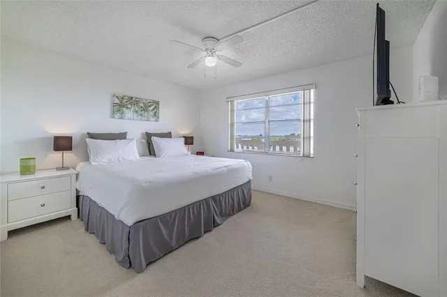 a view of a house with swimming pool and sitting area