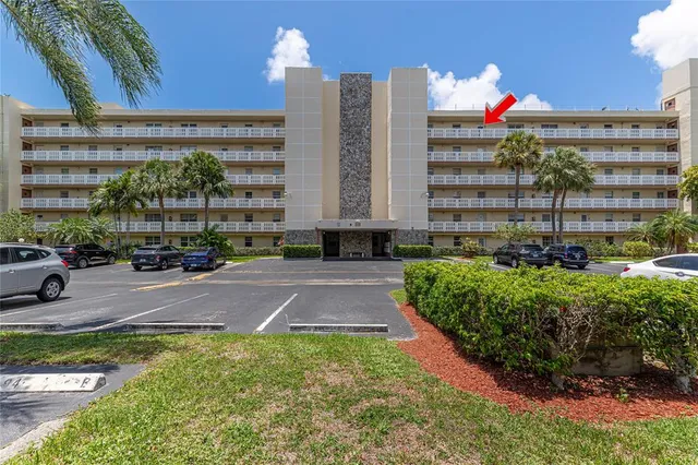 a kitchen with white cabinets and sink