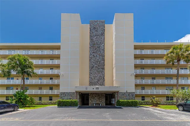 a kitchen with stainless steel appliances kitchen island granite countertop a refrigerator and a stove