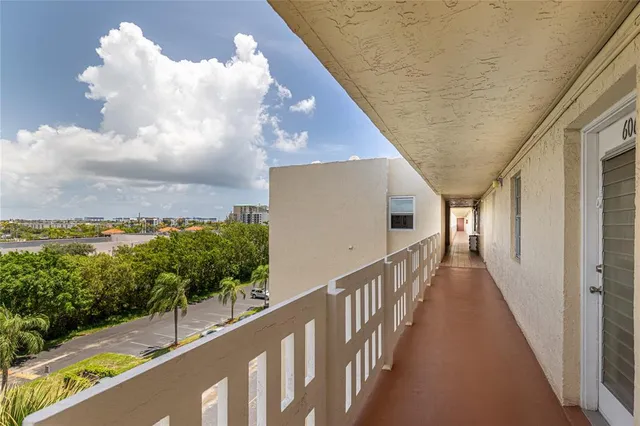 a kitchen with stainless steel appliances granite countertop a refrigerator a stove and a sink