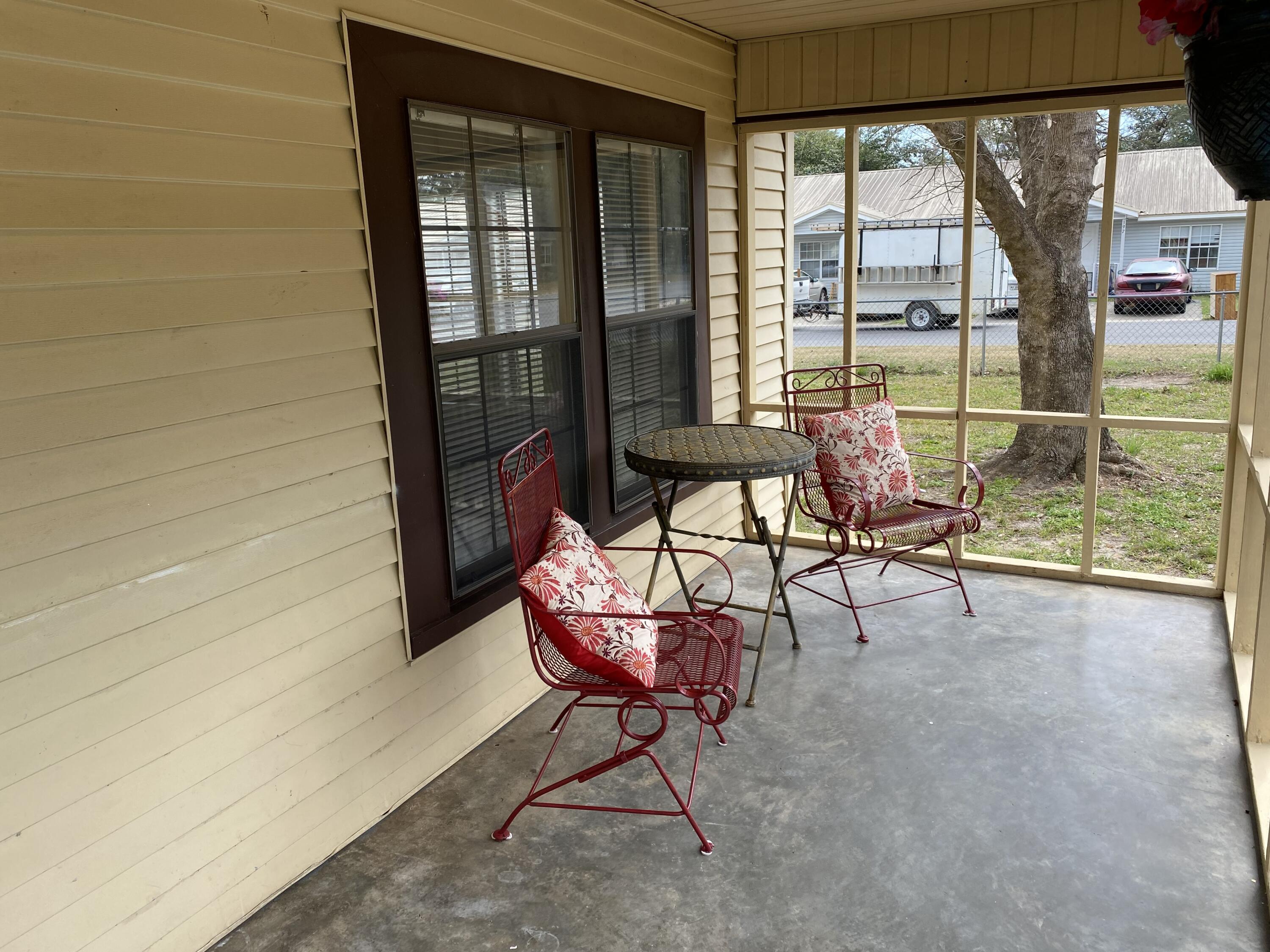 597 South Wilson Street Crestview, FL 32536 - Photo 2 of 16 a living room with furniture and a floor to ceiling window