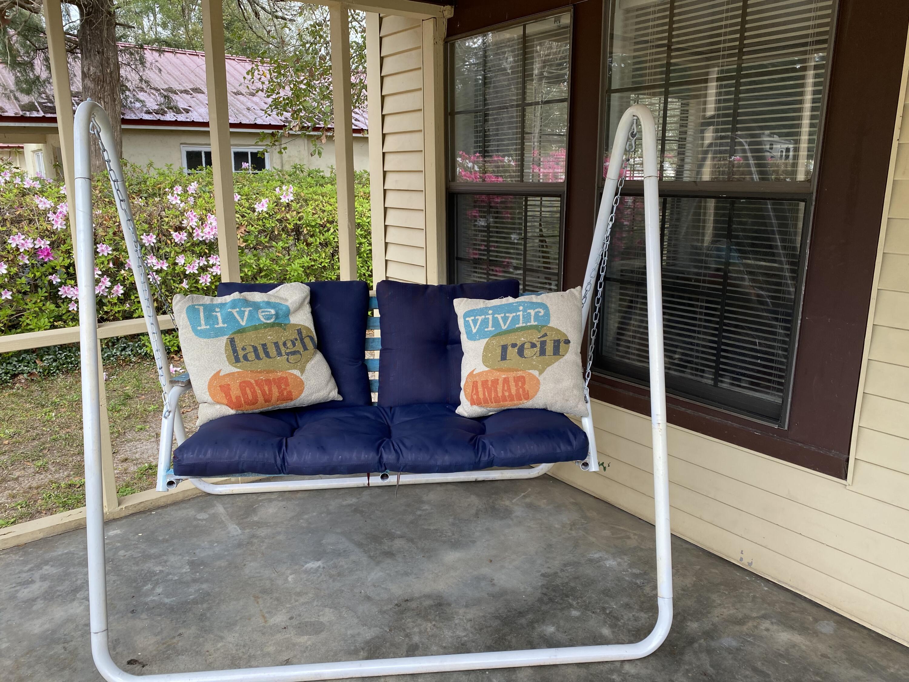 597 South Wilson Street Crestview, FL 32536 - Photo 3 of 16 a view of living room with furniture and floor to ceiling window
