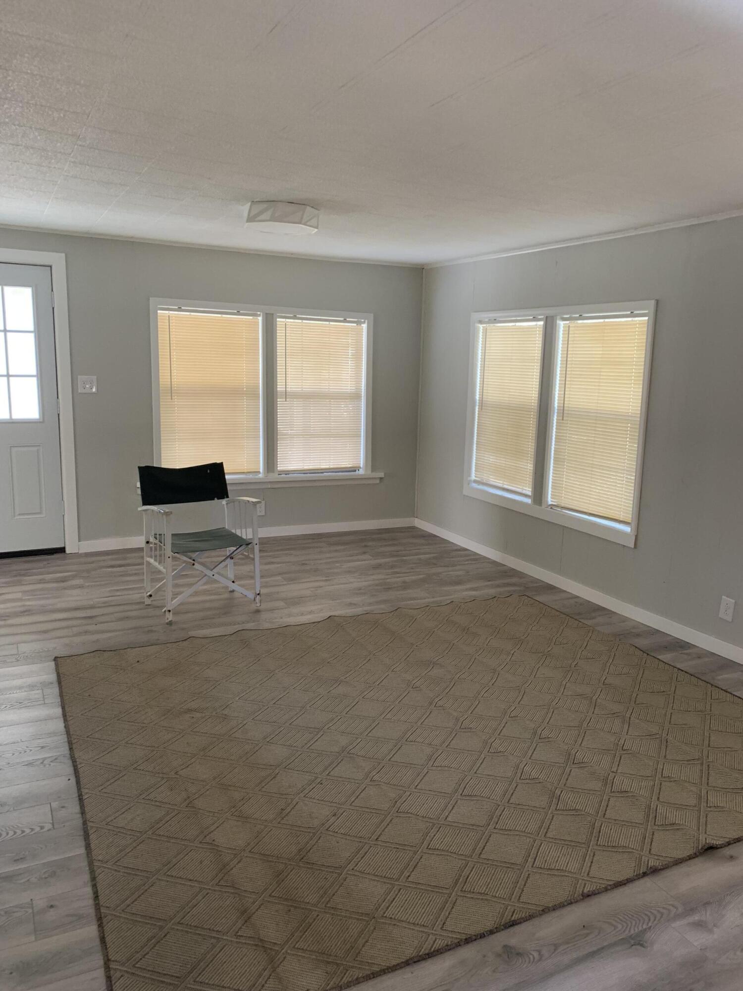 597 South Wilson Street Crestview, FL 32536 - Photo 4 of 16 an empty room with windows