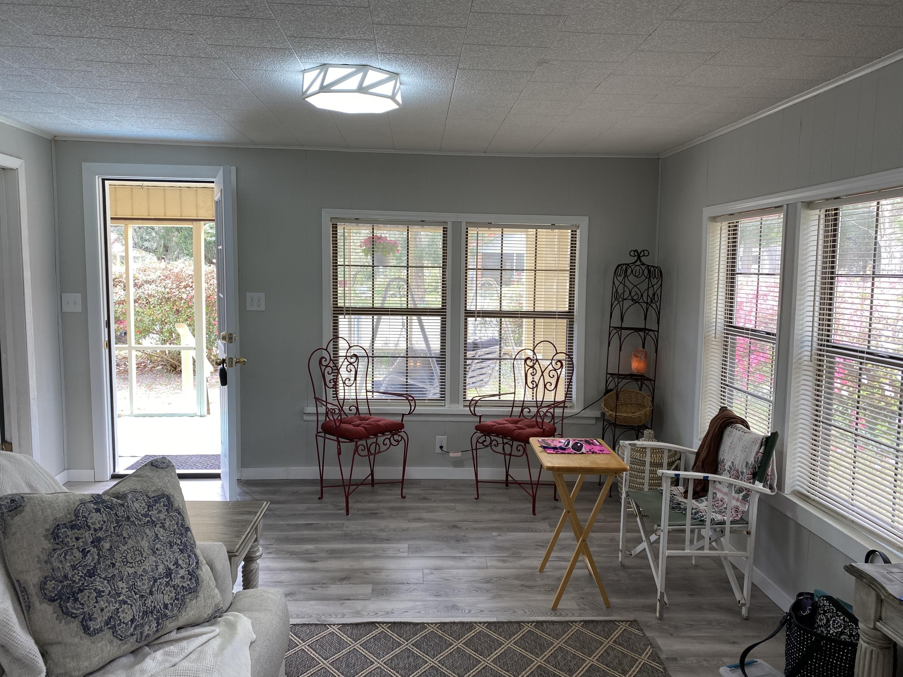 597 South Wilson Street Crestview, FL 32536 - Photo 6 of 16 a living room with furniture and a large window