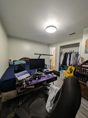 a bedroom with furniture and a chair