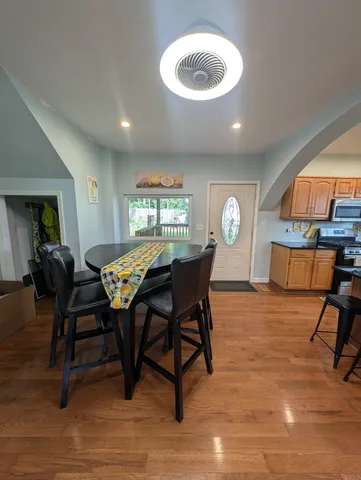 a view of a dining room with furniture and a chandelier