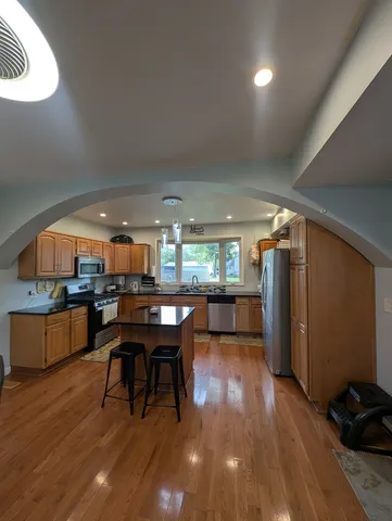 a dining room with furniture and wooden floor