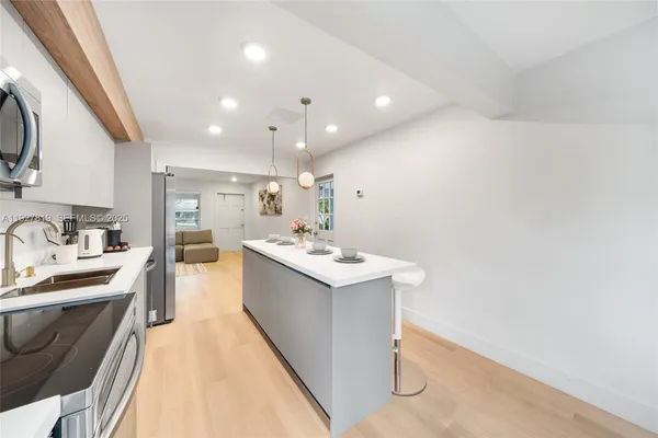 a kitchen with a sink appliances and cabinets