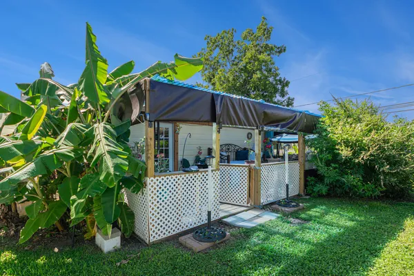 a view of a chair and table in the garden