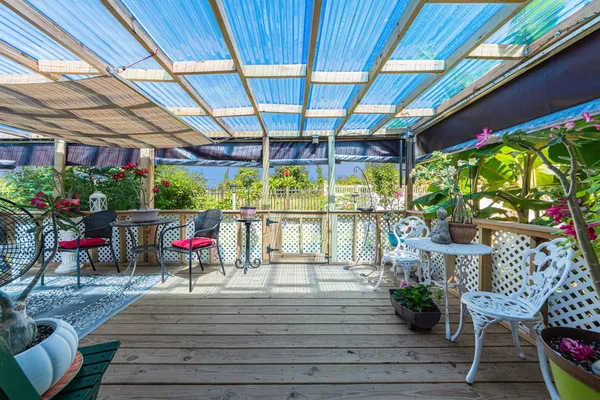 a view of a chairs and table in patio with wooden fence