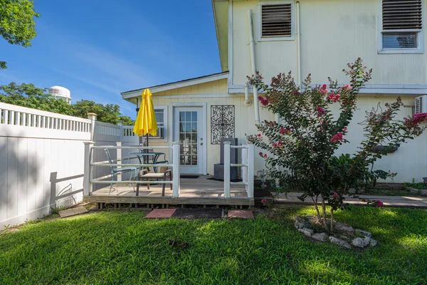 a view of a house with backyard and sitting area