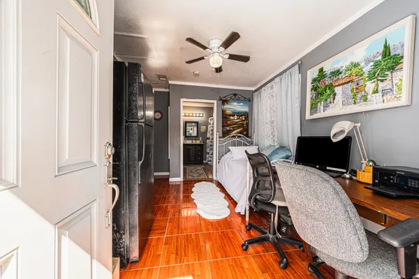 a view of a workspace with furniture and a window