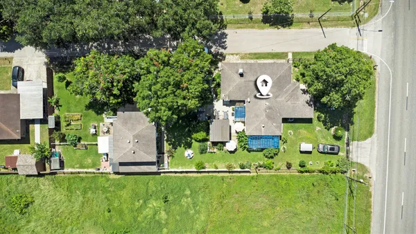 an aerial view of a house with swimming pool garden and mountain view