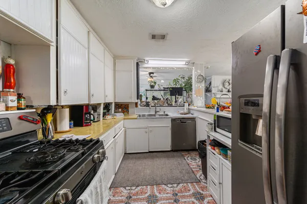 a kitchen with a sink stove and refrigerator