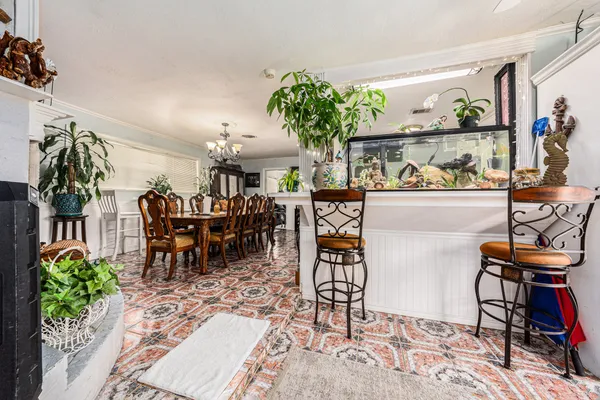 a view of a dining room with furniture and a potted plant