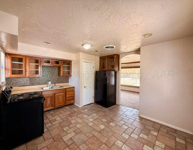 4623 Crockett Street Amarillo, TX 79110 - Photo 4 of 9 a kitchen with granite countertop a refrigerator and a stove