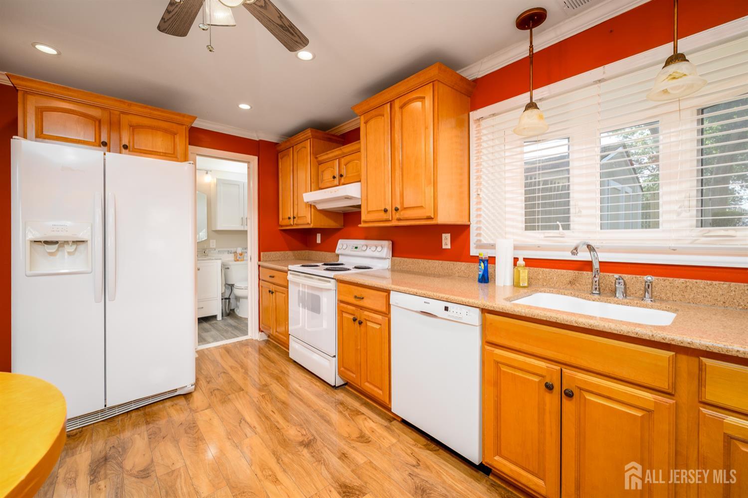 65 Orange Street Edison, NJ 08817 - Photo 12 of 51 a kitchen with stainless steel appliances granite countertop a sink a refrigerator and cabinets