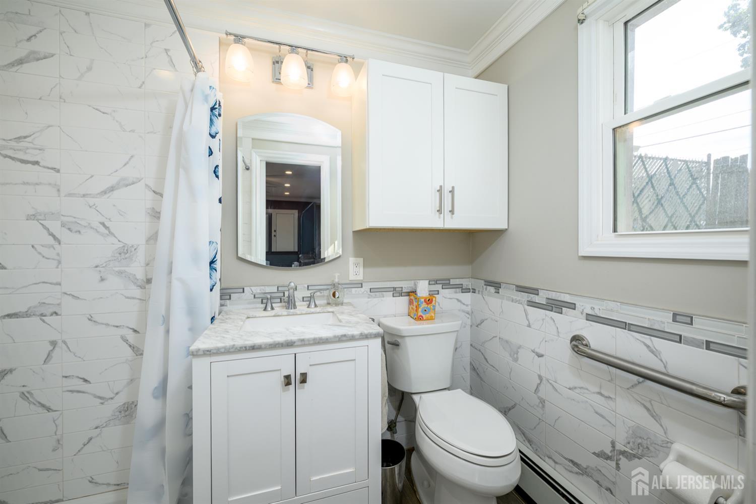 65 Orange Street Edison, NJ 08817 - Photo 33 of 51 a bathroom with a granite countertop toilet sink and mirror
