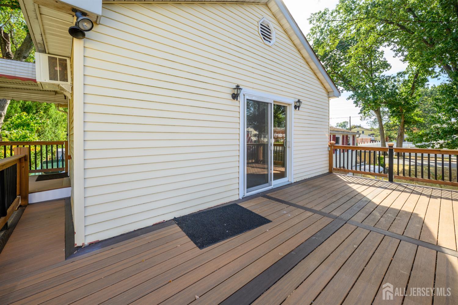 65 Orange Street Edison, NJ 08817 - Photo 46 of 51 a view of a deck with wooden floor and fence and a floor to ceiling window