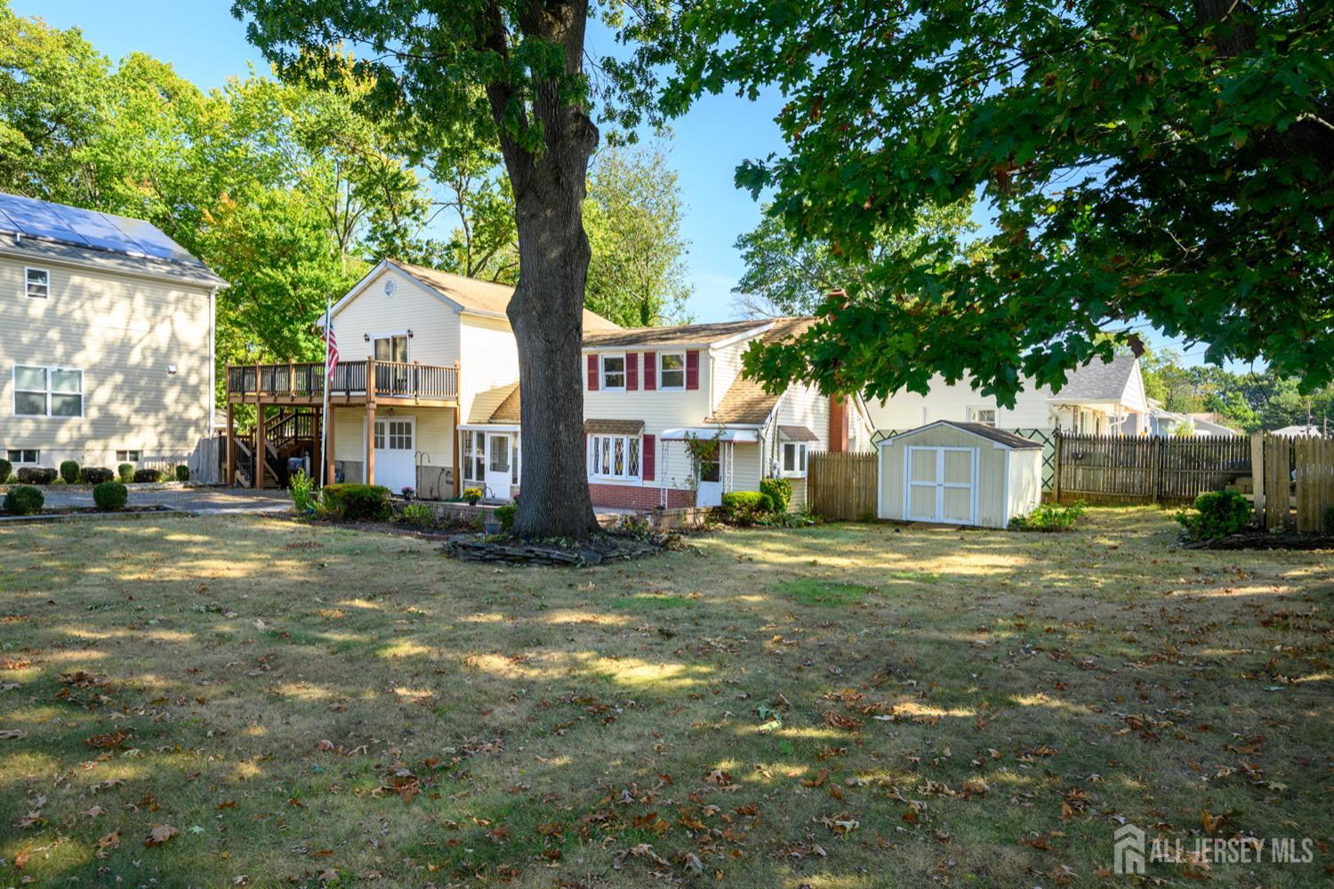 65 Orange Street Edison, NJ 08817 - Photo 6 of 51 a view of a yard in front of a house with large tree