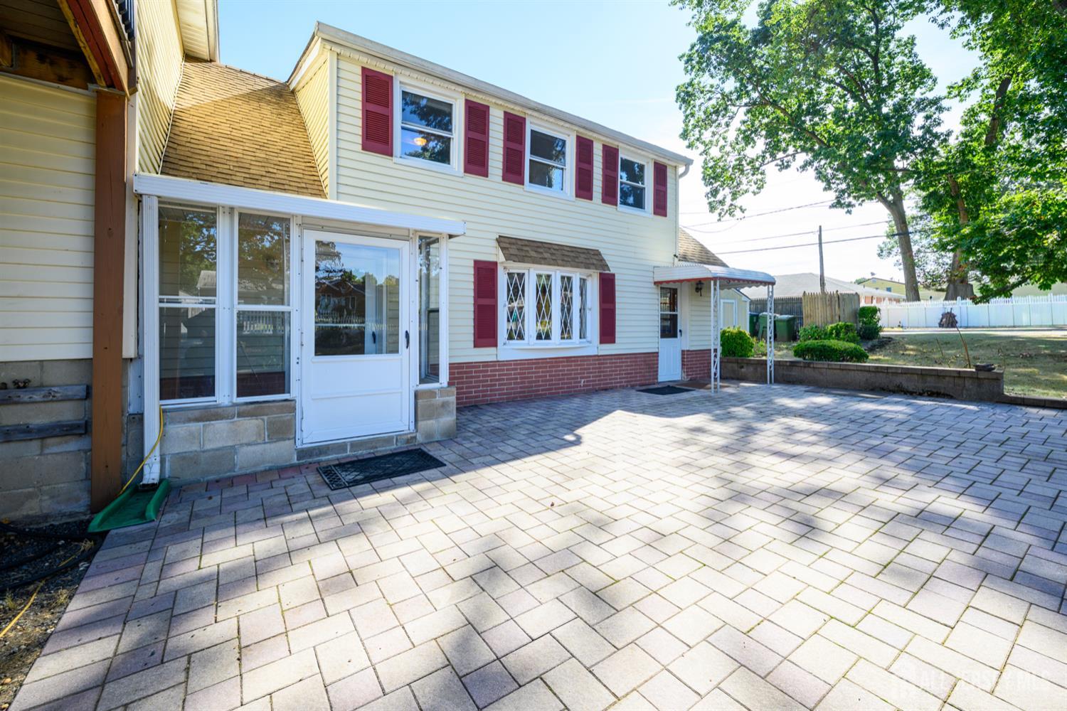 65 Orange Street Edison, NJ 08817 - Photo 10 of 51 a view of a brick house with a yard in front of it