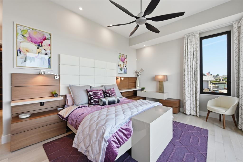 600 Wedge Lane Longboat Key, FL 34228 - Photo 36 of 82 a bedroom with a bed and a chandelier