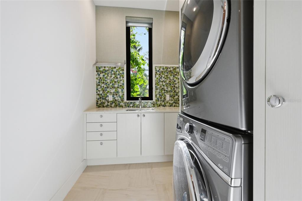 600 Wedge Lane Longboat Key, FL 34228 - Photo 63 of 82 image of a utility room with a sink and a mirror