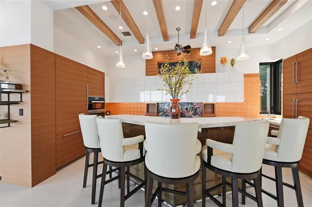 a roof deck with a couch and chairs