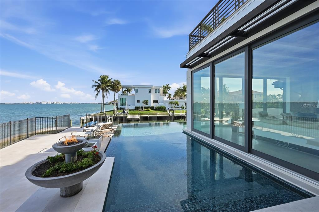 600 Wedge Lane Longboat Key, FL 34228 - Photo 78 of 82 a dining room with furniture and a floor to ceiling window