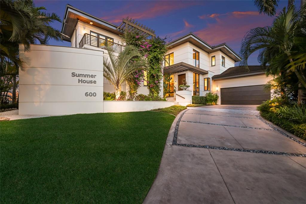 600 Wedge Lane Longboat Key, FL 34228 - Photo 80 of 82 a front view of a house with a garden and yard
