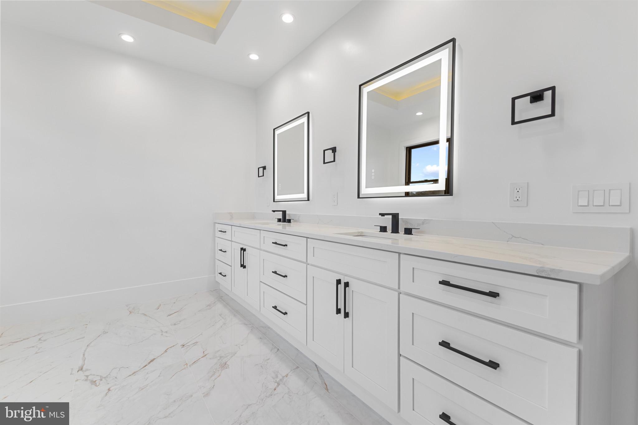 1912 Anderson Road Falls Church, VA 22043 - Photo 24 of 40 a bathroom with a double vanity sink and mirror
