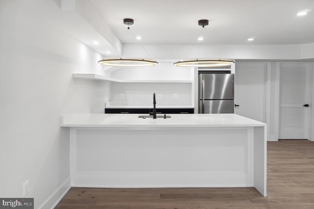 1912 Anderson Road Falls Church, VA 22043 - Photo 32 of 40 a kitchen with kitchen island a sink and wooden floor