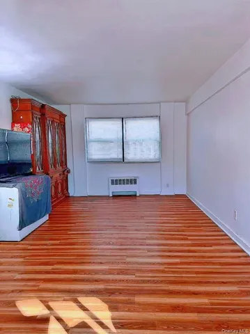 a room with a bed and a flat screen tv