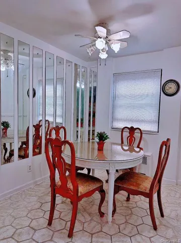 a dining room with furniture and chandelier