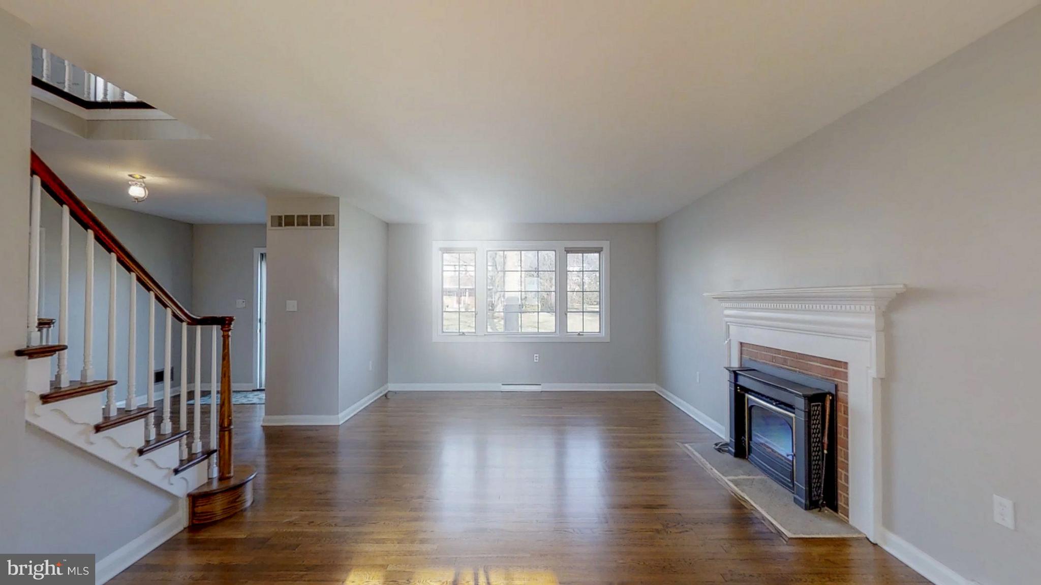 2402 Brickton Road Wilmington, DE 19803 - Photo 5 of 25 Spacious formal living room with brick fireplace