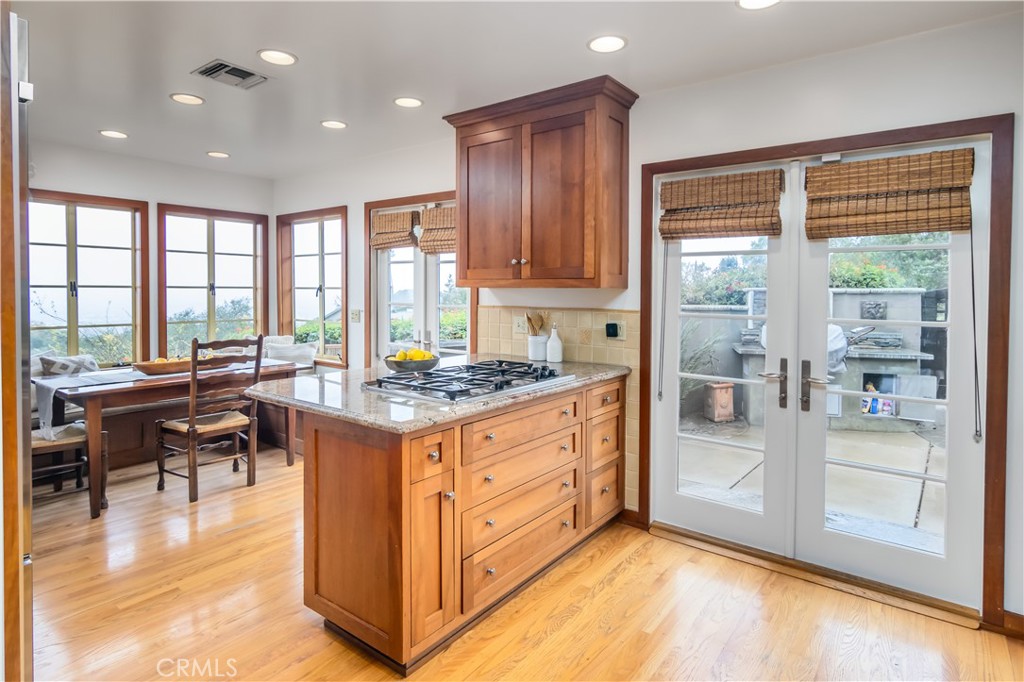 751 Ridgeside Drive Monrovia, CA 91016 - Photo 20 of 65 a kitchen with kitchen island granite countertop a stove and a view of living room