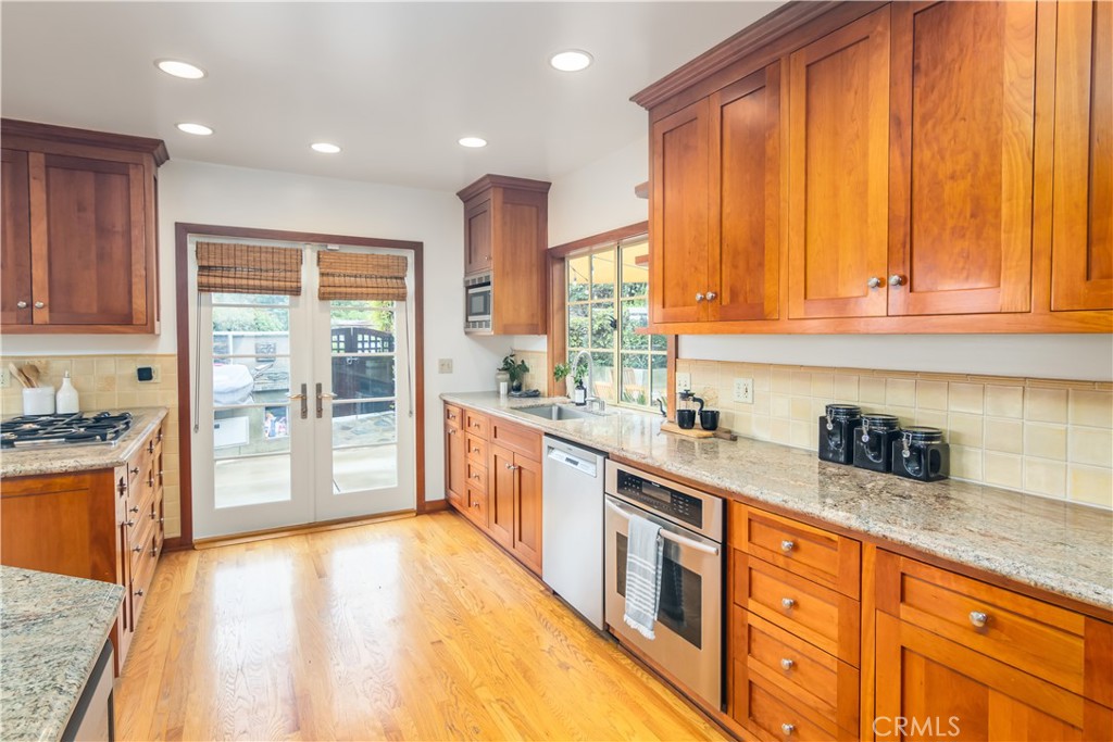 751 Ridgeside Drive Monrovia, CA 91016 - Photo 22 of 65 a large kitchen with stainless steel appliances granite countertop a refrigerator a stove top oven and a sink with cabinets