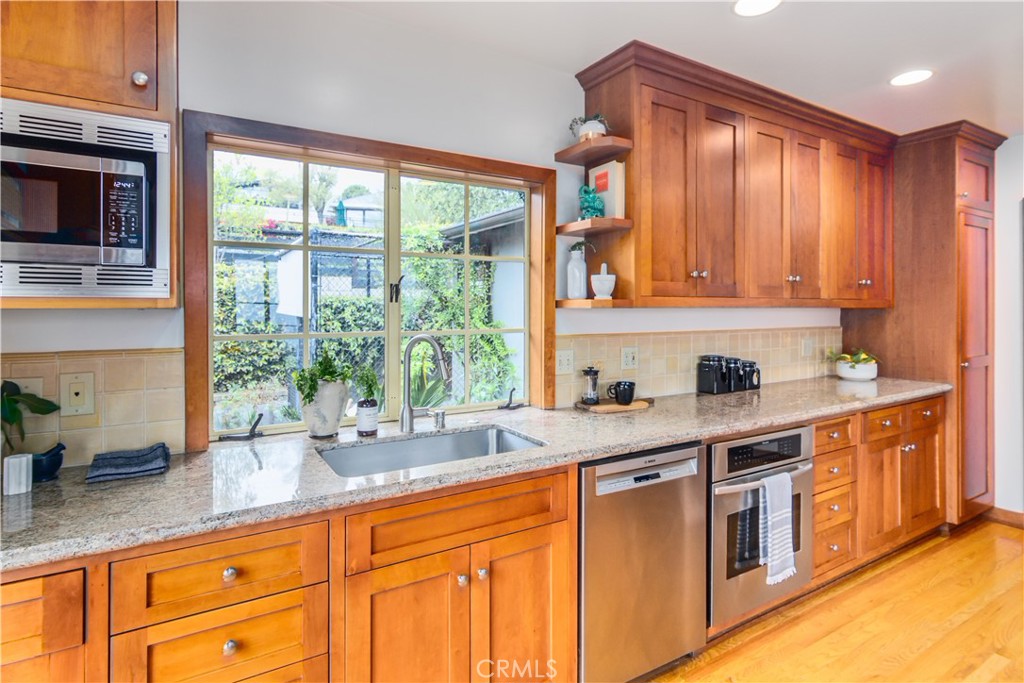 751 Ridgeside Drive Monrovia, CA 91016 - Photo 23 of 65 a kitchen with stainless steel appliances granite countertop a sink a stove and a microwave