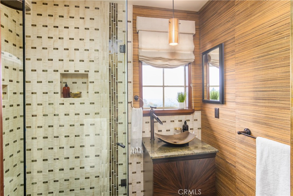 751 Ridgeside Drive Monrovia, CA 91016 - Photo 32 of 65 a bathroom with a window a sink and a mirror
