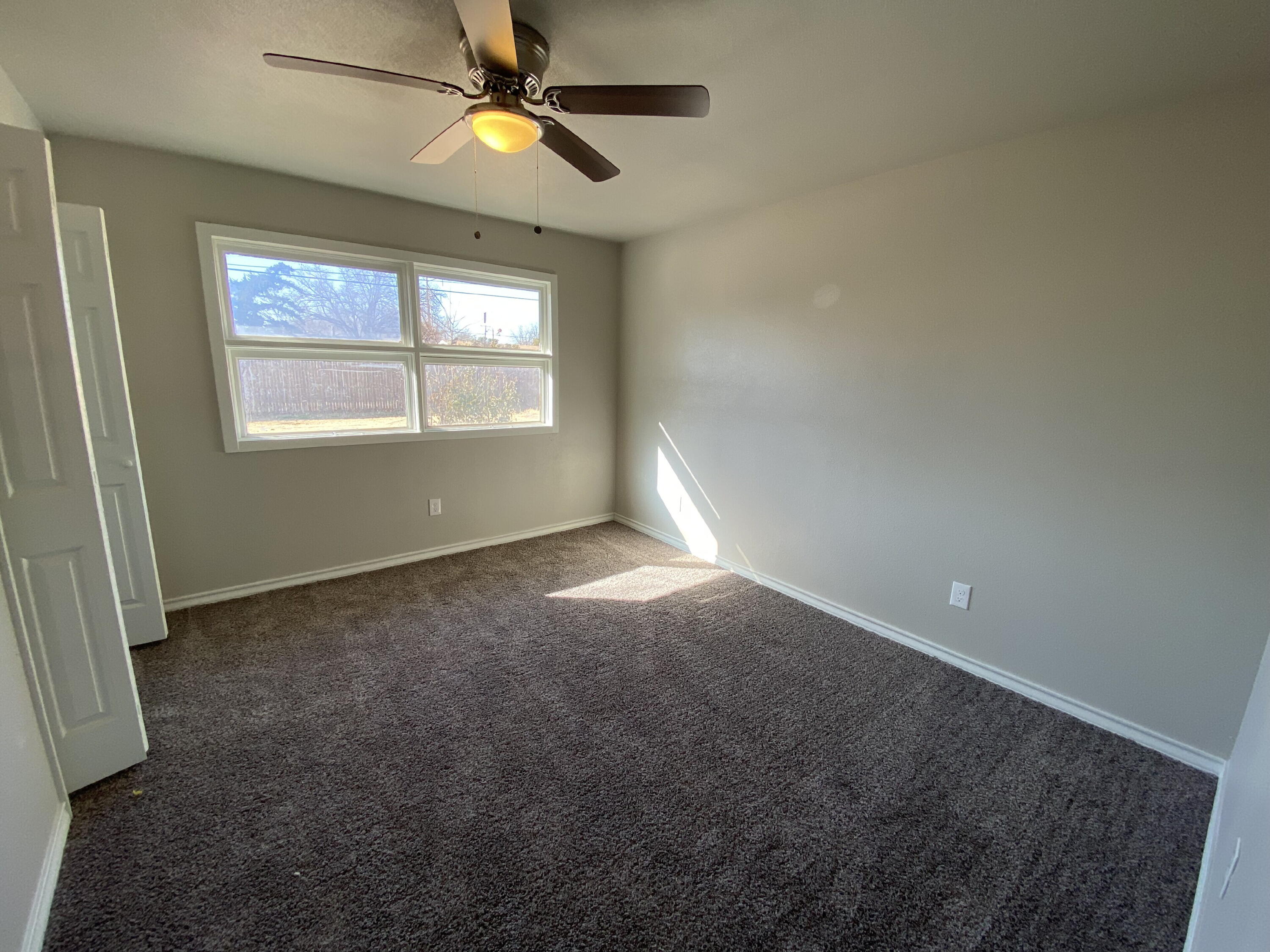 2823 56th Street Lubbock, TX 79413 - Photo 12 of 15 an empty room with windows and fan