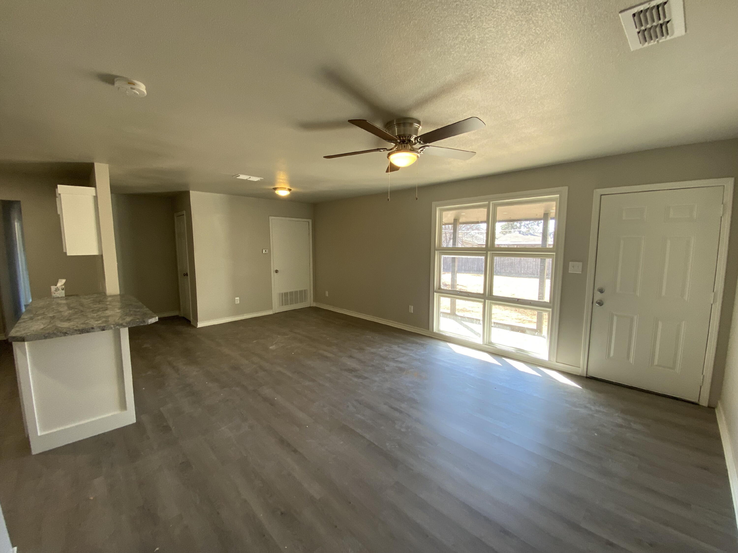 2823 56th Street Lubbock, TX 79413 - Photo 5 of 15 an empty room with wooden floor and windows