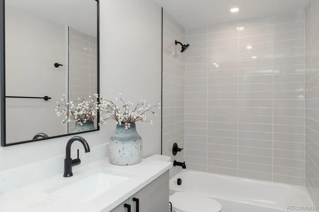 a bathroom with a sink a toilet and a bathtub